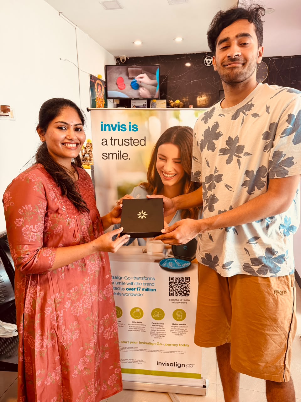 Visitor and Glodent team member holding an Invisalign presentation box in Perungudi Chennai